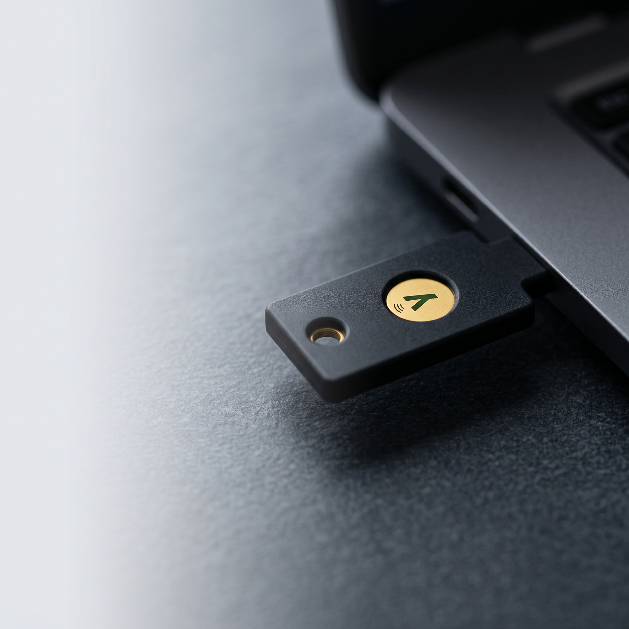 YubiKey 5 NFC hardware security key inserted into a laptop USB port