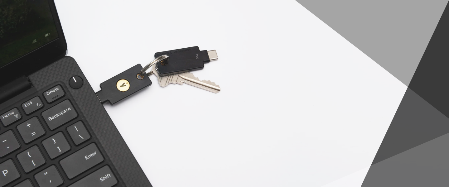 Laptop with a Yubico Security Key plugged in and a spare Security Key attached to the same keyring
